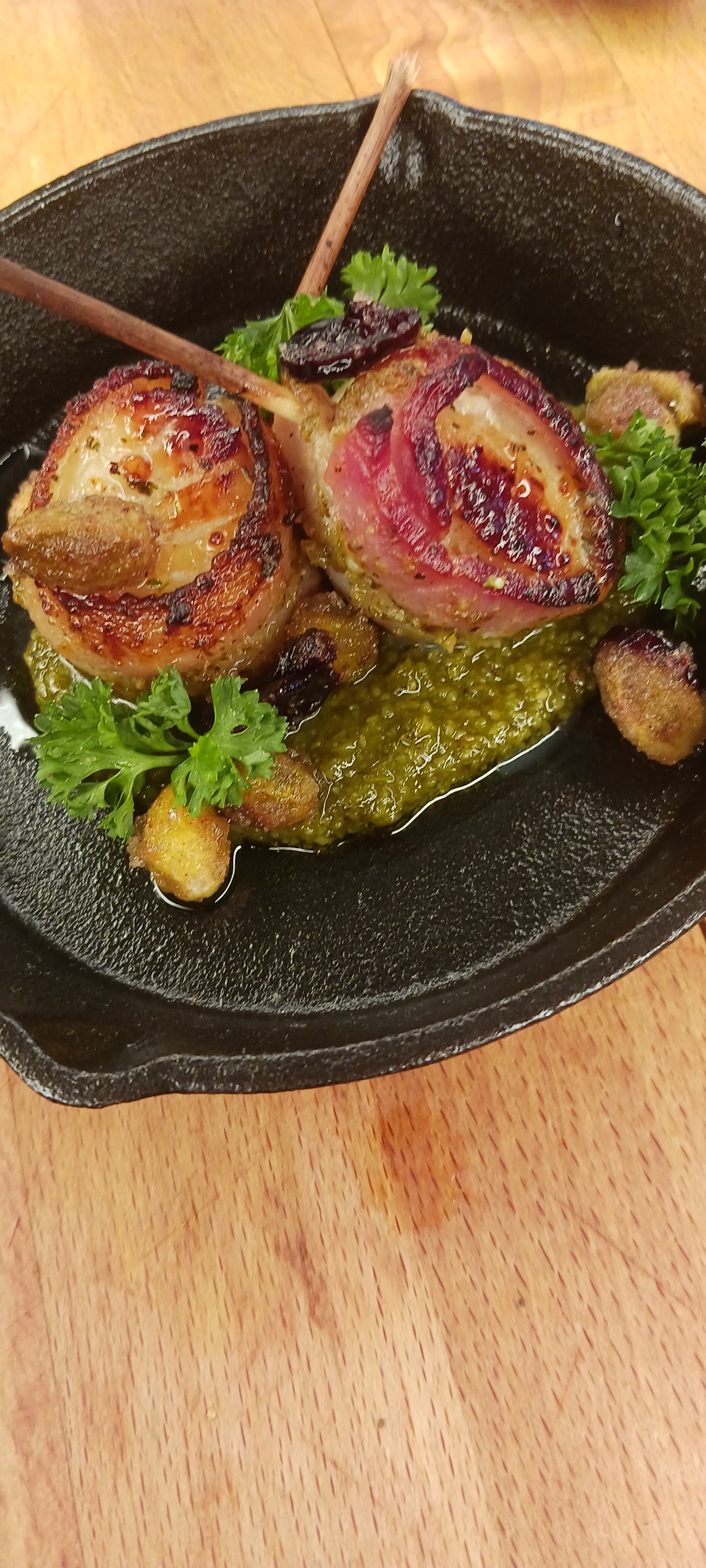 Cast iron seared medallions on pesto with cranberry reduction