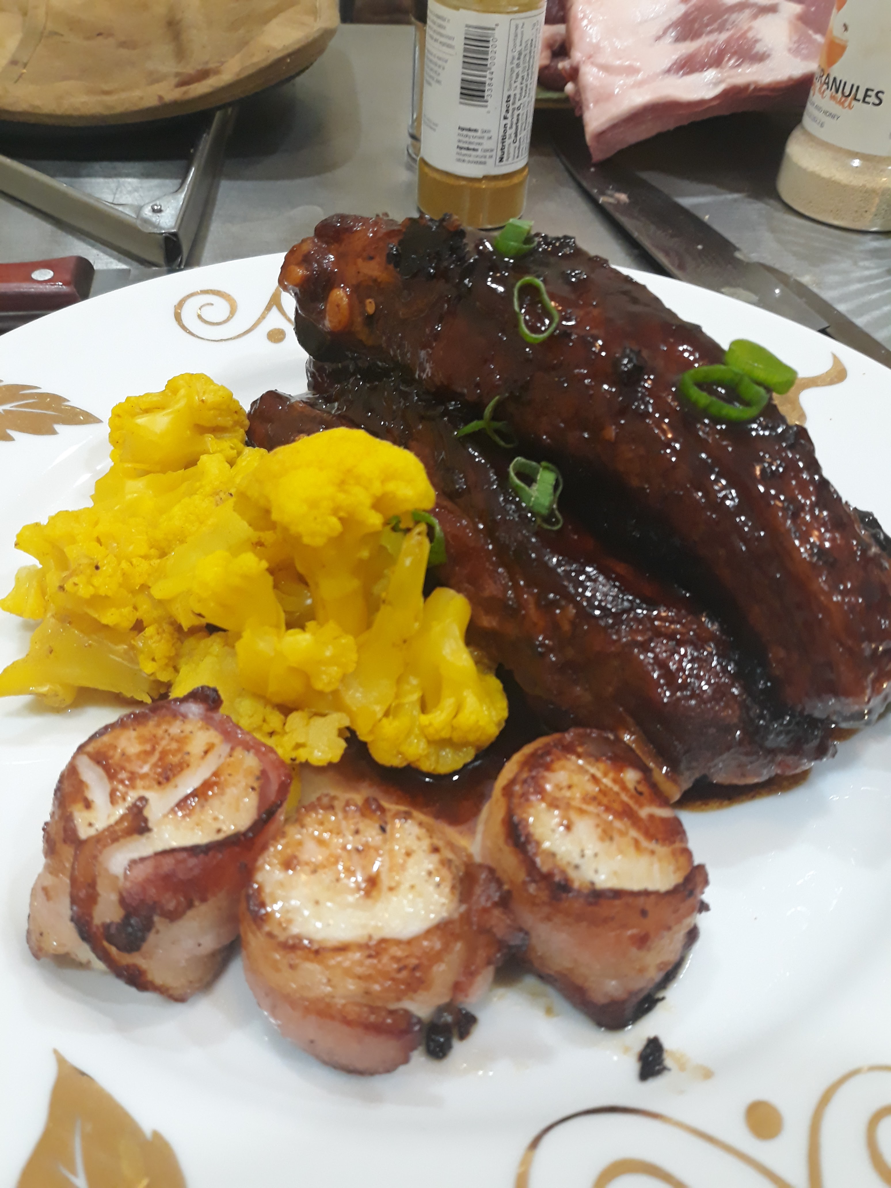 Glazed short ribs with seared scallops and turmeric cauliflower
